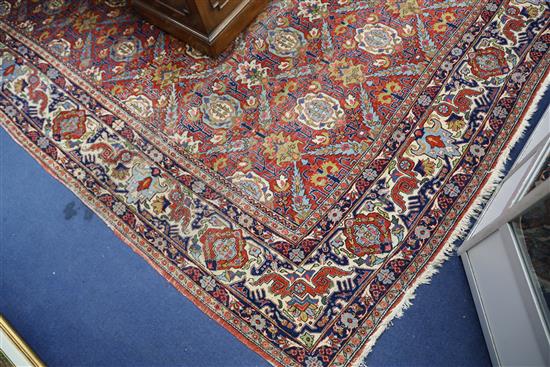 A Persian red ground carpet, 11ft x 7ft 11in.